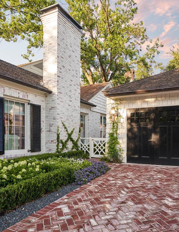 A limewash brick house with timeless features and herringbone brick driveway