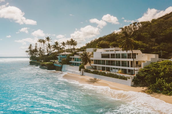 modern beach houses next to crystal blue ocean