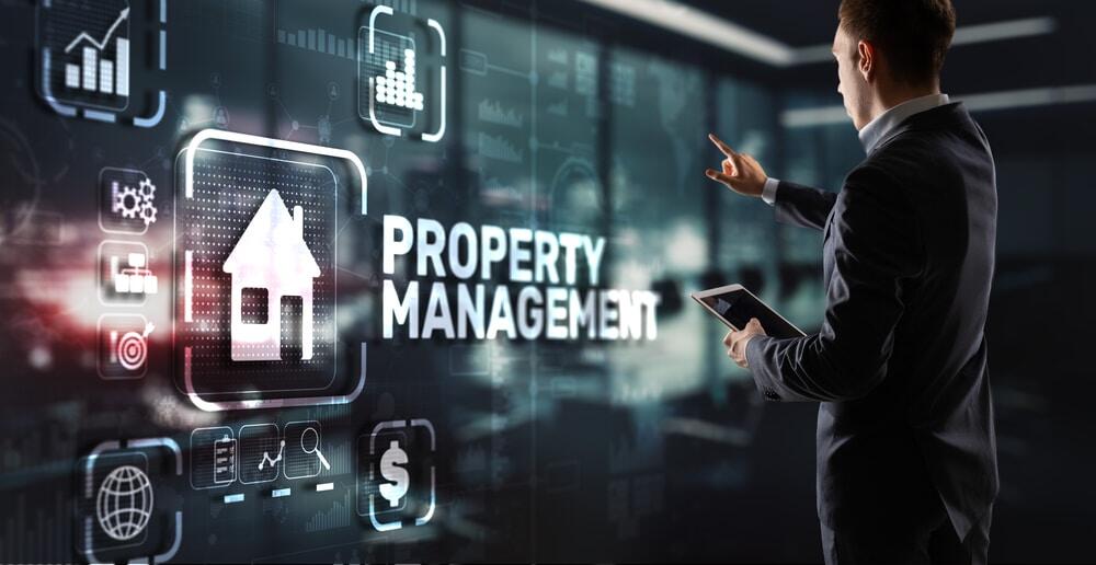 man in suit pointing at property management IT support icons