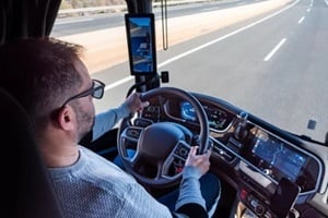 truck driver driving a truck on a highway