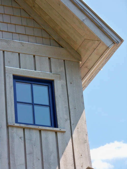 Natural wood board and batten exterior with black grid windows