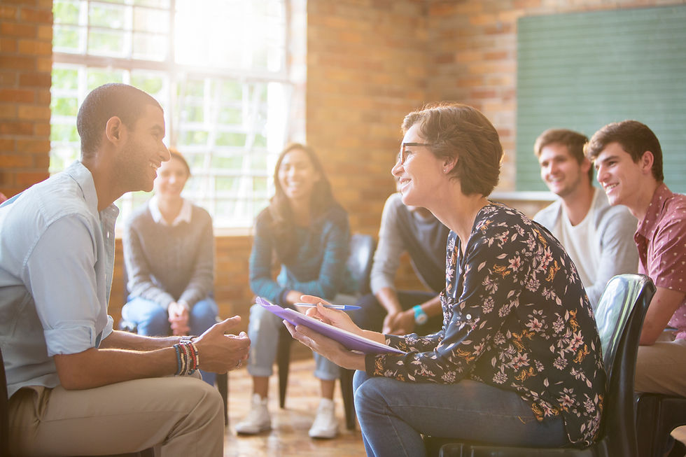 This is a picture of seven people sitting in a circle, talking to each other. 