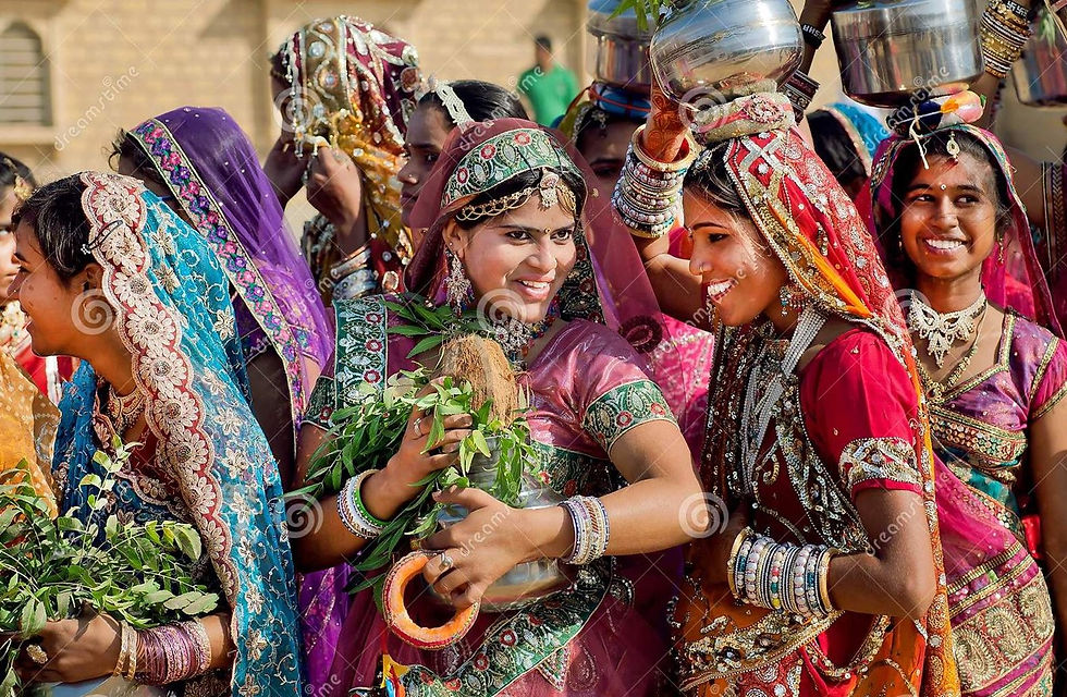 This is a picture of nine young Indian women who are all wearing Sarees of different colors. The women are smiling, and they're also wearing other traditional accessories, such as bangles.