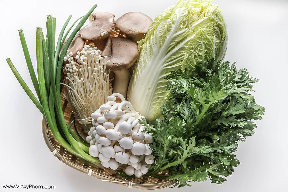 A bowl that has six varieties of Hot Pot vegetables, including lettuce, green onions, and three kinds of mushrooms. 