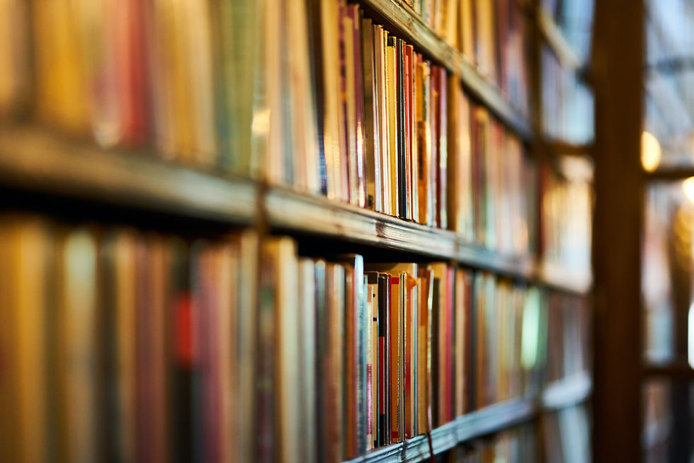 A bookshelf lined with multicolored books