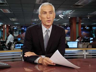 This is a picture of Jorge Ramos sitting behind an Anchor's desk.