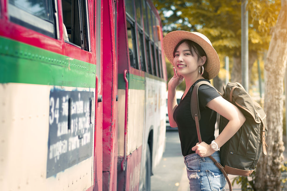 This is a picture of a young woman about to board a bus. 