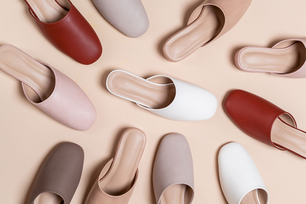 This is a picture of a bunch of slip-on shoes in different colors. 