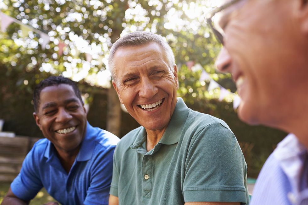 This is a picture of three men sitting outside and talking. 