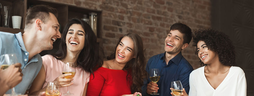 This is a picture of five friends sitting together, enjoying a conversation and drinks.