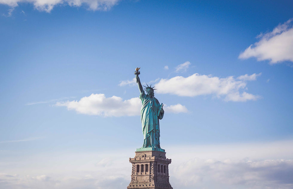 A picture of the Statue of Liberty against a partly cloudy sky.
