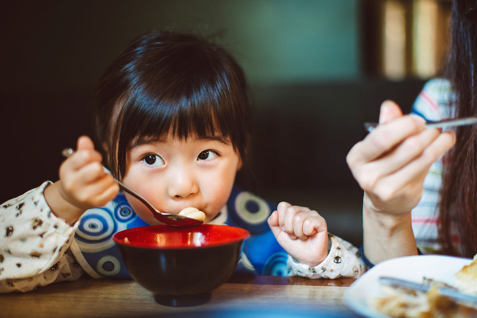 little girl enjoys soup