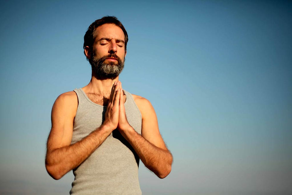 This is a picture of a man holding the "Namaste" position. 