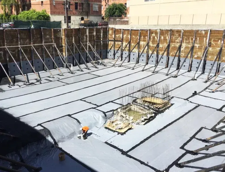 A construction site with the applied below-grade waterproofing system.