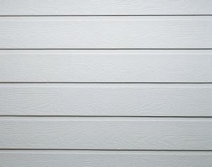 The image shows a close up shot of a white garage door with a wood-like texture.